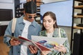 Smiling young couple holding vinyl records in music store Royalty Free Stock Photo