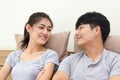 Smiling young couple looking at each other face on the bed Royalty Free Stock Photo