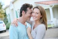 Smiling young couple outisde in front of their house Royalty Free Stock Photo