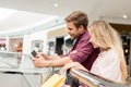 smiling young couple with shopping bags using digital tablet with blank screen Royalty Free Stock Photo