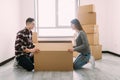 Smiling young couple unpacking carton boxes in a new house Royalty Free Stock Photo