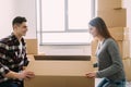 Smiling young couple unpacking carton boxes in a new house Royalty Free Stock Photo