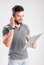 Smiling young delivery man holding and holding a clipboard Royalty Free Stock Photo