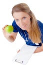 Smiling young doctor giving an green apple. Royalty Free Stock Photo