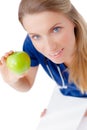 Smiling young doctor giving an green apple. Royalty Free Stock Photo