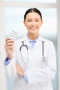 Smiling young doctor with pills and sthethoscope Royalty Free Stock Photo