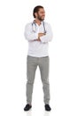 Handsome Young Doctor Is Standing With Arms Crossed And Looking At The Side. Front View Royalty Free Stock Photo