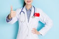 Smiling young doctor woman making thumb up gesture Royalty Free Stock Photo