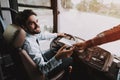 Smiling Young Driver taking Ticket from Passenger Royalty Free Stock Photo