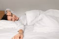 Smiling young european female sleeping on white bed, waking up, enjoying good morning, weekend Royalty Free Stock Photo