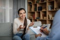 Smiling young european lady patient talking, gesturing with male doctor in office clinic interior Royalty Free Stock Photo