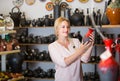 Young woman selecting ceramics with red enamel in atelier Royalty Free Stock Photo