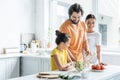 smiling young family cooking together and having fun