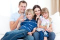 Smiling young family singing a karaoke together Royalty Free Stock Photo