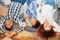 smiling young family with son looking at camera while lying together on bed. Happy young father, mother and cute child boy Royalty Free Stock Photo