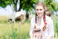 Smiling young farmer carrying bowl of fresh milk Royalty Free Stock Photo
