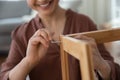Smiling young female assembling flat pack furniture using hex key Royalty Free Stock Photo