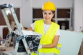 Smiling young female builder with paint bucket and roller Royalty Free Stock Photo