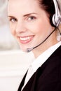 Smiling young female callcenter agent with headset