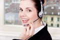 Smiling young female callcenter agent with headset