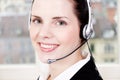 Smiling young female callcenter agent with headset