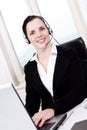 Smiling young female callcenter agent with headset