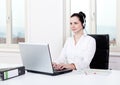 Smiling young female callcenter agent with headset