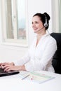 Smiling young female callcenter agent with headset