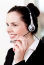 Smiling young female callcenter agent with headset