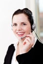 Smiling young female callcenter agent with headset