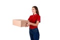 Smiling young female courier is giving a parcel box to a client isolated on white background Royalty Free Stock Photo