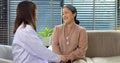 Smiling young female doctor enjoying conversation with happy senior woman Royalty Free Stock Photo