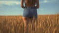 smiling young female farmer cowgirl standing in wheat cereal field. copy space