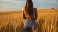 smiling young female farmer cowgirl standing in wheat cereal field. copy space