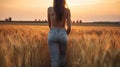 smiling young female farmer cowgirl standing in wheat cereal field. copy space