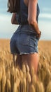 smiling young female farmer cowgirl standing in wheat cereal field. copy space