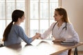 Smiling female doctor handshake patient at meeting Royalty Free Stock Photo