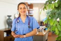 Smiling young female health worker standing in medical office Royalty Free Stock Photo