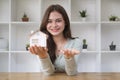 Smiling young female holding house model and keys. Real estate or property Royalty Free Stock Photo