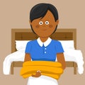 Smiling young female housekeeper carrying towels in hotel
