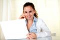 Smiling young female looking at you with laptop Royalty Free Stock Photo