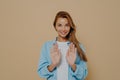 Smiling young female model with stright long hair wearing oversized blue shirt