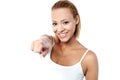 Smiling young female pointing you out Royalty Free Stock Photo