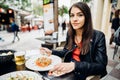 Smiling young female  at a restaurant  having luch in outdoors. Healthy lifestyle, eating salad for lunch.City break trip.Eating Royalty Free Stock Photo