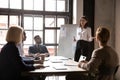 Smiling young female speaker presenting market research results. Royalty Free Stock Photo