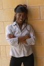 Smiling Young Female Student Against Brick Wall