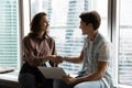 Smiling young female team leader shaking hands with male employee. Royalty Free Stock Photo