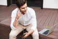 Smiling young formal dressed man in earphones Royalty Free Stock Photo