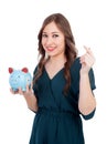 Smiling young girl with a blue money-box