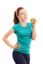 Smiling young girl in fitness clothes holding an apple Royalty Free Stock Photo